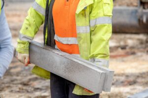 Close,Up,Of,Groundworker,In,Orange,And,Yellow,Hi-viz,Carrying